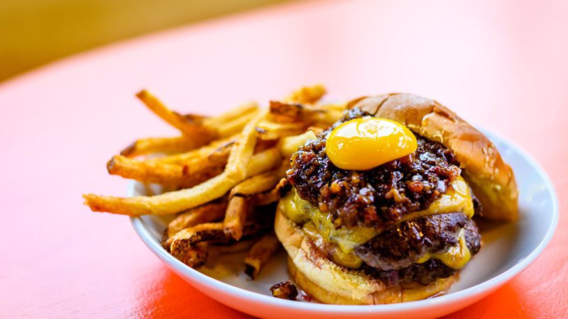 The Big Day Burger with some extras: jammy-sweet bacon agrodolce and a perfect confit egg yolk.